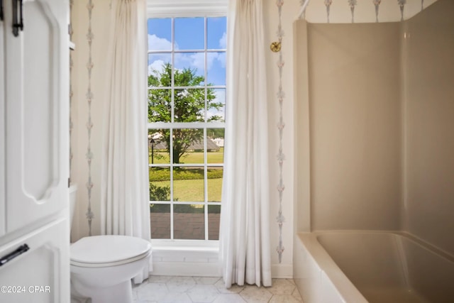 bathroom with toilet, tile flooring, and shower / bath combo with shower curtain