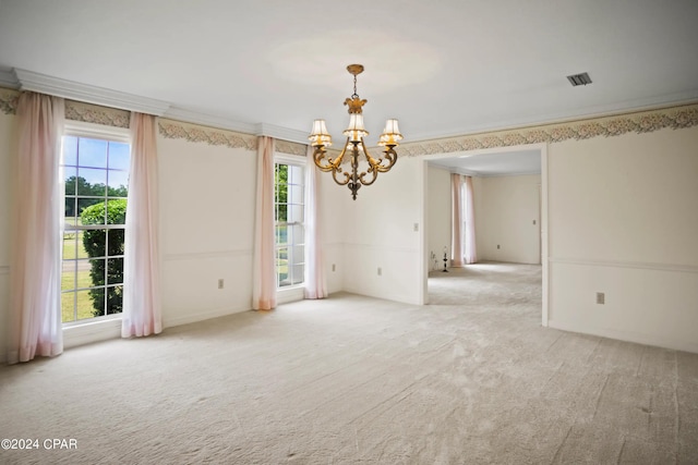 carpeted empty room featuring ornamental molding and plenty of natural light