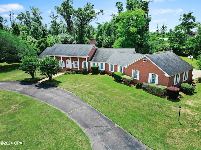 single story home with a porch and a front yard