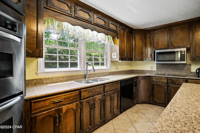 kitchen with dark brown cabinetry, sink, plenty of natural light, and black appliances