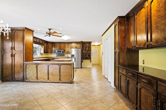 kitchen with stainless steel appliances, ceiling fan, sink, and light tile flooring