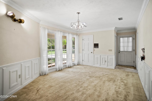 entryway with light colored carpet, a notable chandelier, and ornamental molding