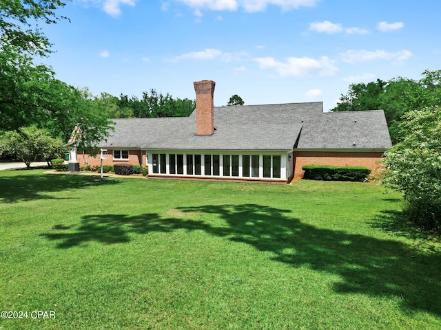 rear view of house with a yard