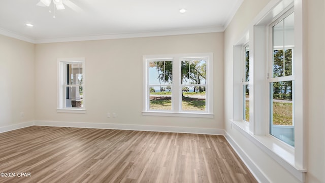 empty room with ceiling fan, ornamental molding, and hardwood / wood-style flooring