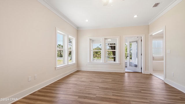 spare room with ornamental molding and wood-type flooring