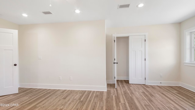 unfurnished room with light wood-type flooring