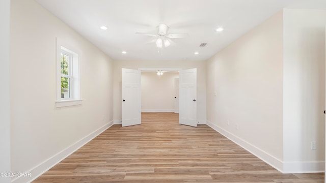 spare room featuring light hardwood / wood-style floors and ceiling fan