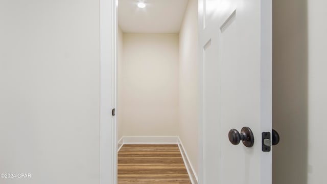 hallway with wood-type flooring