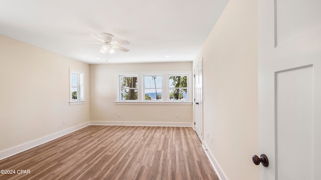 unfurnished room with ceiling fan and hardwood / wood-style floors