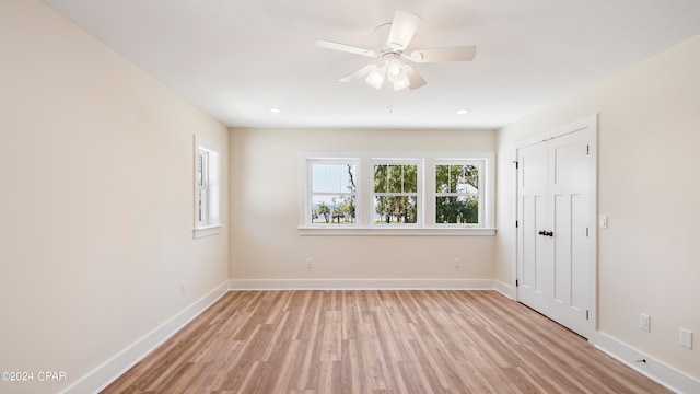 spare room with ceiling fan and light hardwood / wood-style flooring