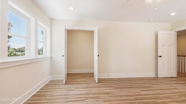 spare room with ceiling fan and light hardwood / wood-style flooring