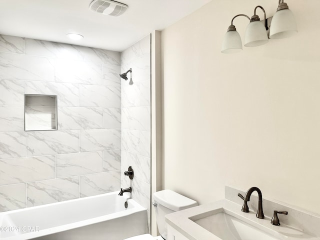 full bathroom with vanity, toilet, and tiled shower / bath combo