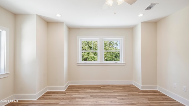 spare room with ceiling fan and light wood-type flooring