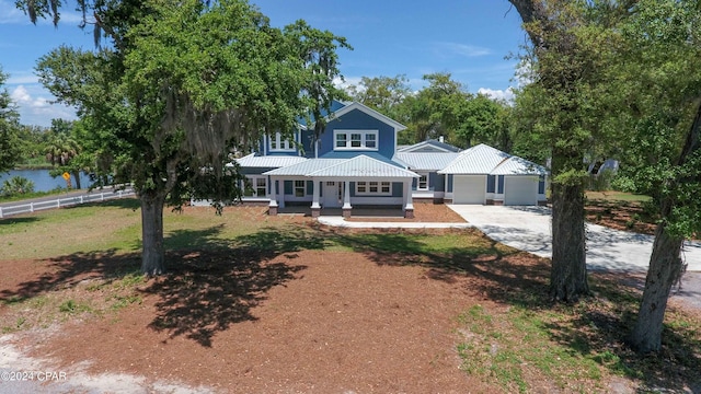 view of front of house with an outdoor structure, a garage, a front yard, and a porch