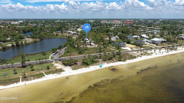 birds eye view of property with a view of the beach and a water view