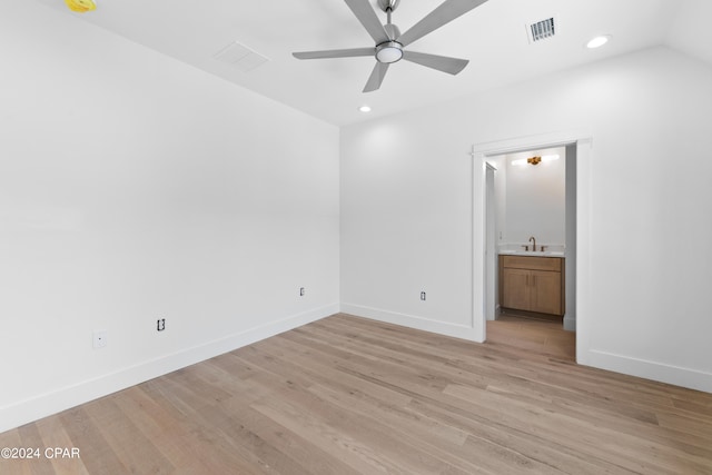 spare room featuring vaulted ceiling, sink, ceiling fan, and light hardwood / wood-style floors