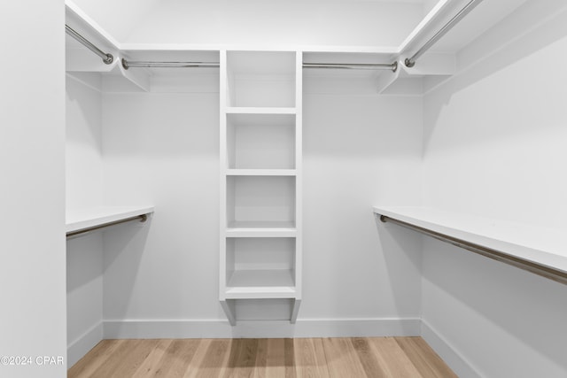 spacious closet featuring light hardwood / wood-style floors