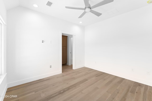 empty room featuring light hardwood / wood-style floors, ceiling fan, and vaulted ceiling