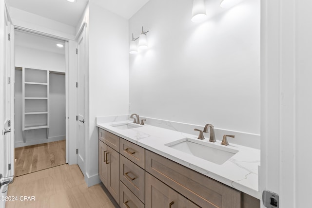 bathroom featuring hardwood / wood-style floors and double vanity