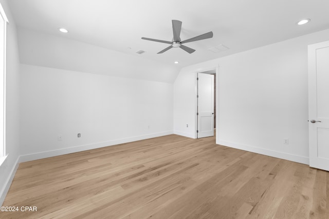 spare room with light hardwood / wood-style floors, ceiling fan, and vaulted ceiling