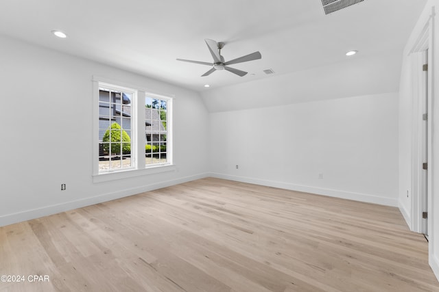 unfurnished room with lofted ceiling, ceiling fan, and light hardwood / wood-style floors