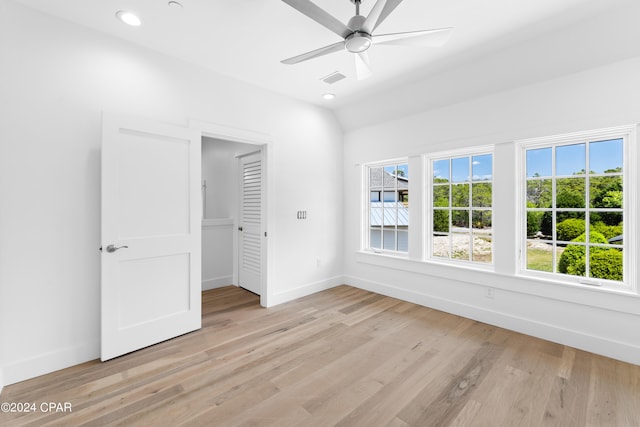 unfurnished bedroom featuring a closet, light hardwood / wood-style floors, and ceiling fan