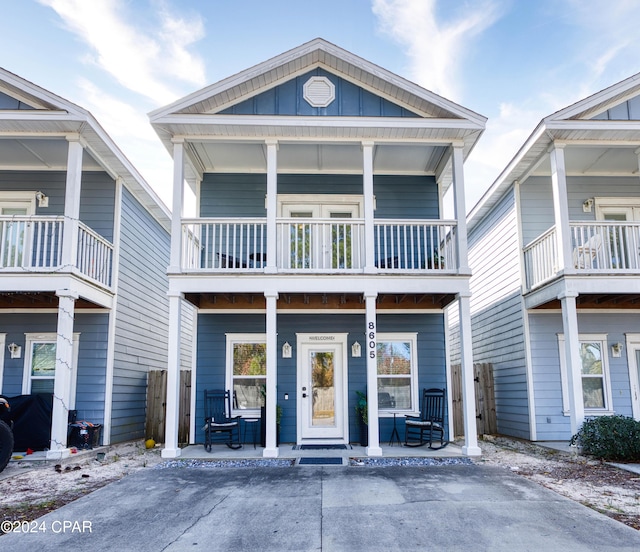 view of front of house with a porch and a balcony