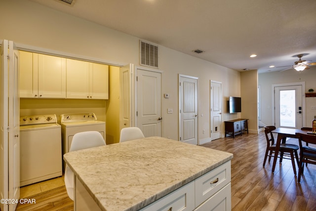 kitchen with ceiling fan, light hardwood / wood-style flooring, white cabinets, and independent washer and dryer