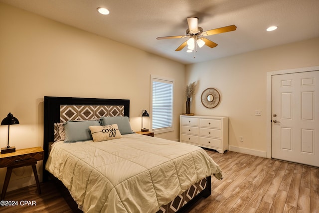 bedroom with ceiling fan and light hardwood / wood-style flooring