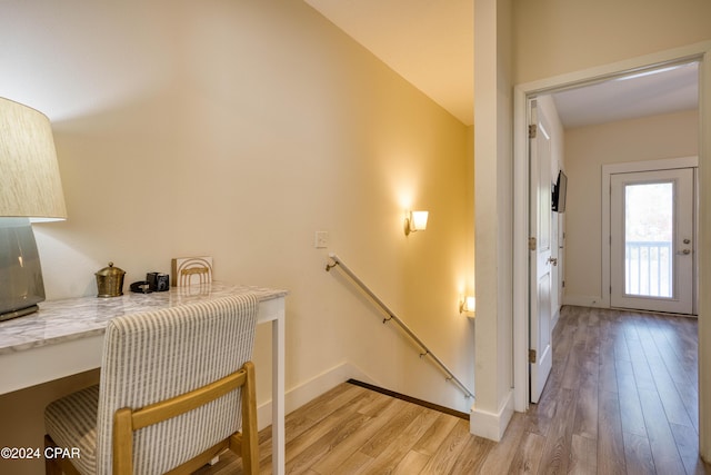 stairway featuring hardwood / wood-style floors and lofted ceiling