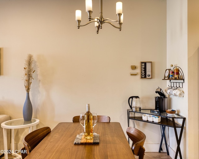 dining space with a notable chandelier and hardwood / wood-style flooring