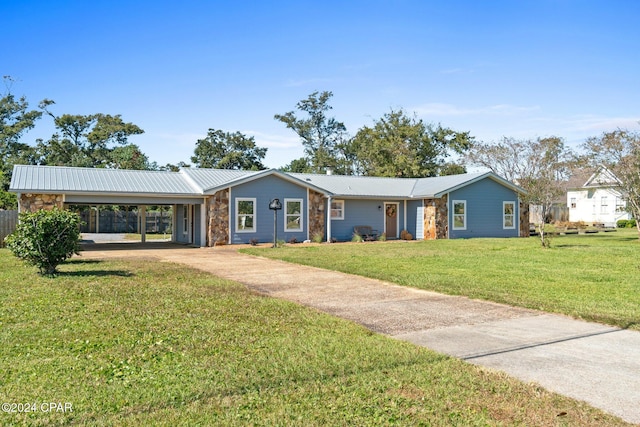 ranch-style house featuring a carport and a front lawn