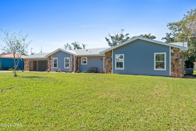 rear view of house featuring a lawn