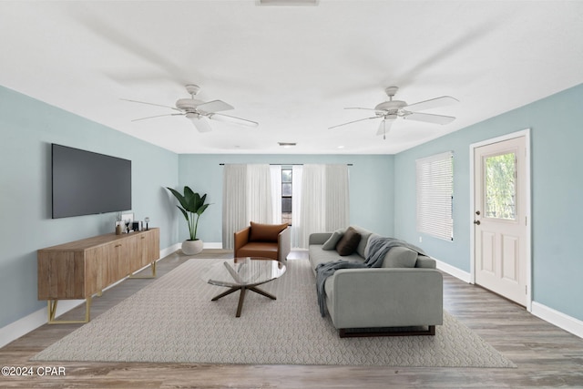 living room with hardwood / wood-style flooring and ceiling fan