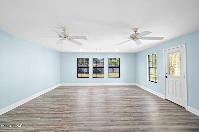 unfurnished room with dark wood-type flooring and ceiling fan