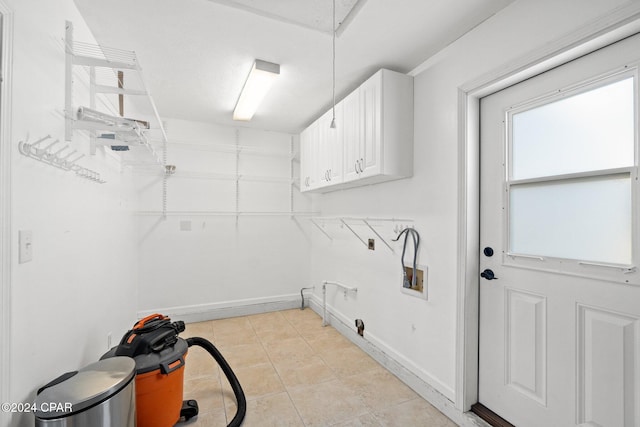 laundry room with light tile patterned floors, washer hookup, cabinets, and hookup for a gas dryer