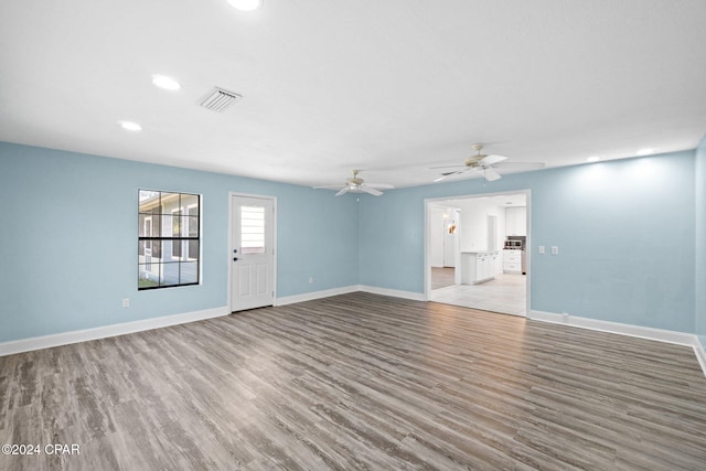 unfurnished living room with light hardwood / wood-style flooring and ceiling fan