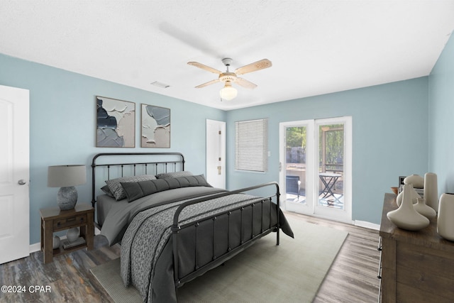 bedroom featuring ceiling fan, dark hardwood / wood-style floors, and access to exterior