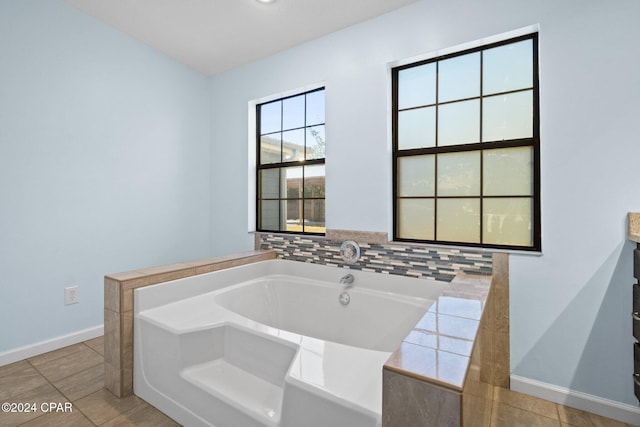 bathroom with a bathtub and tile patterned flooring