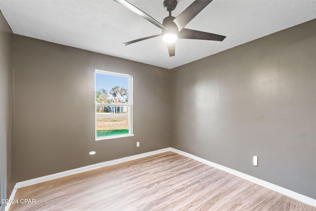 spare room with light hardwood / wood-style flooring, a textured ceiling, and ceiling fan