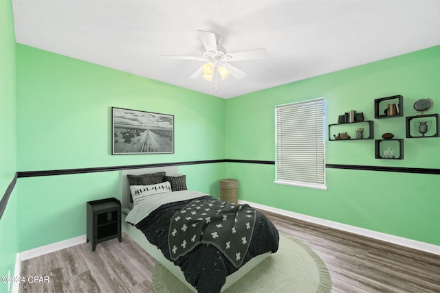 bedroom with light hardwood / wood-style floors and ceiling fan