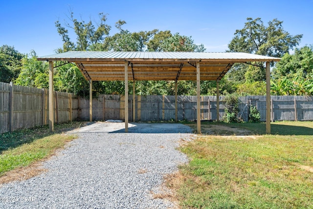 view of car parking featuring a yard and a carport