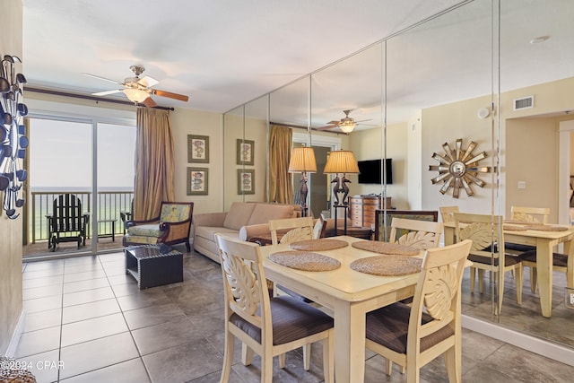 tiled dining space featuring ceiling fan