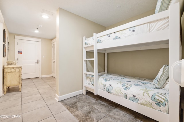 tiled bedroom featuring a closet