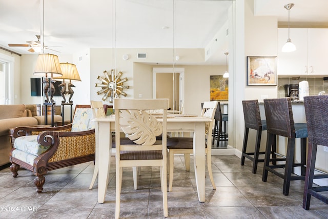 tiled dining room with ceiling fan