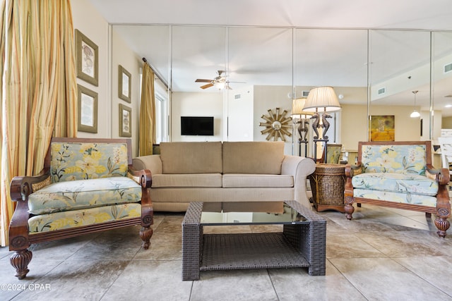 living room featuring tile flooring and ceiling fan