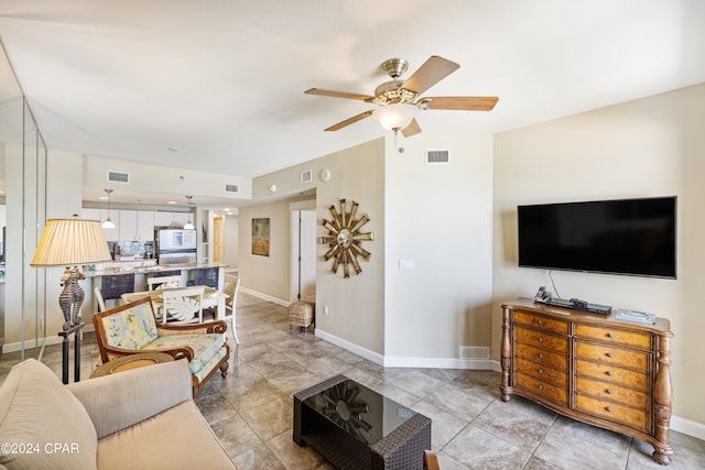 tiled living room with ceiling fan