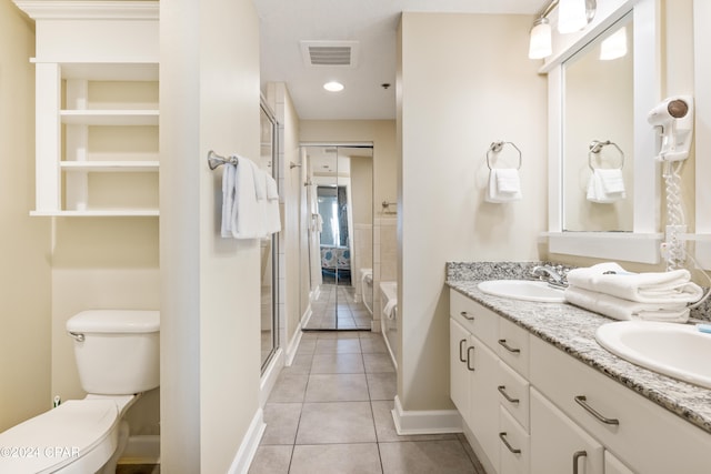 bathroom with toilet, tile floors, and dual bowl vanity