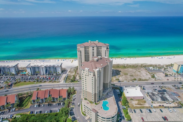 bird's eye view featuring a water view and a beach view