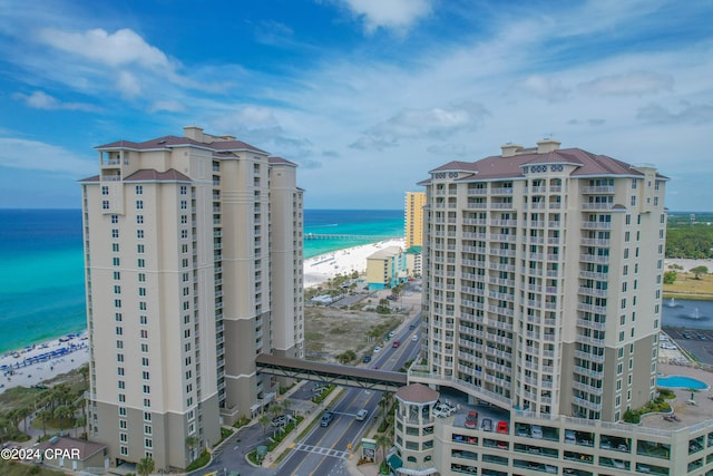 exterior space with a water view and a view of the beach